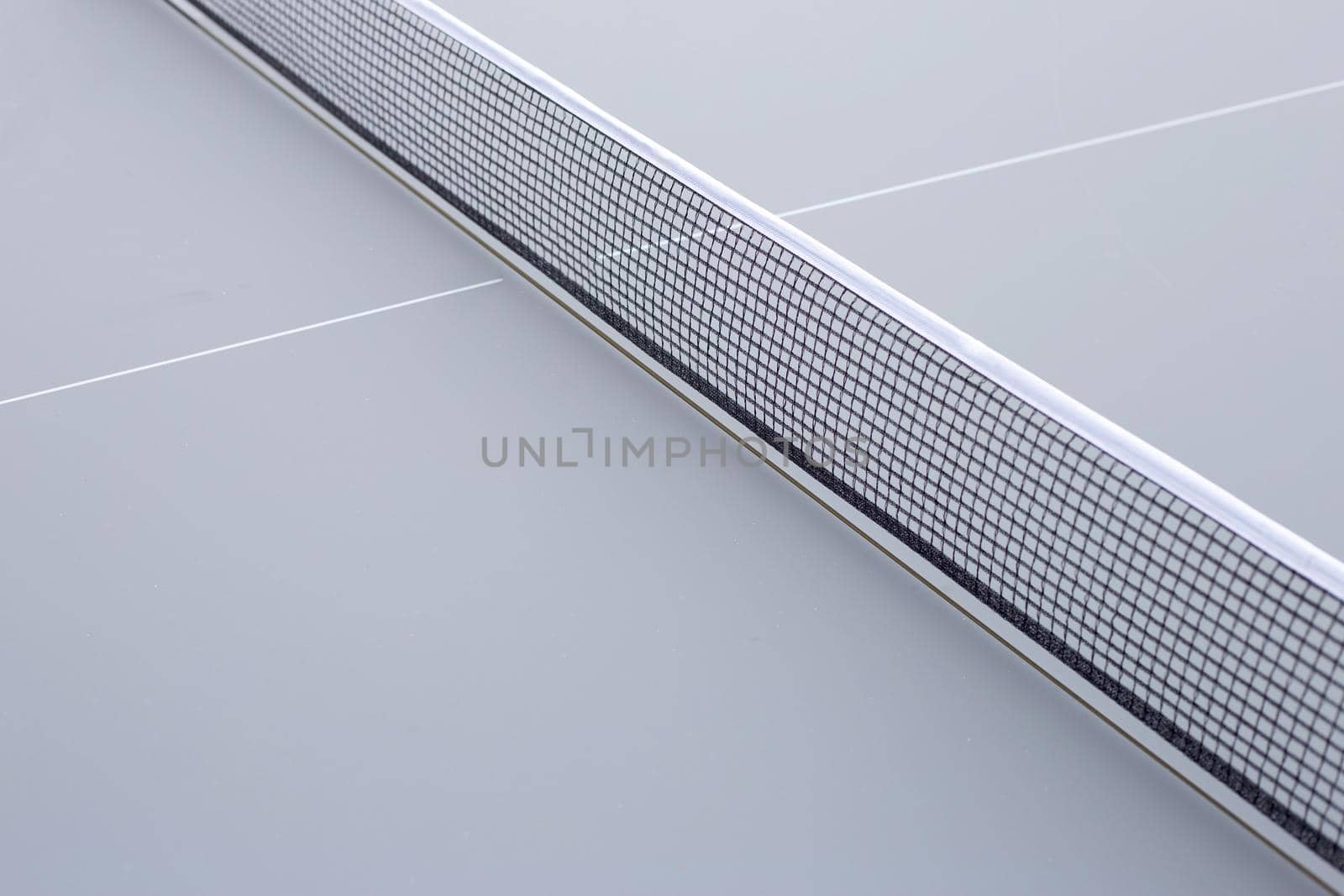 Net of table tennis ping pong on grey background.