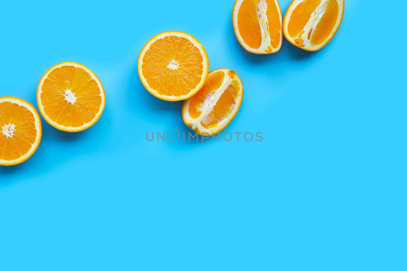 High vitamin C, Juicy and sweet. Fresh orange fruit  on blue background. Top view