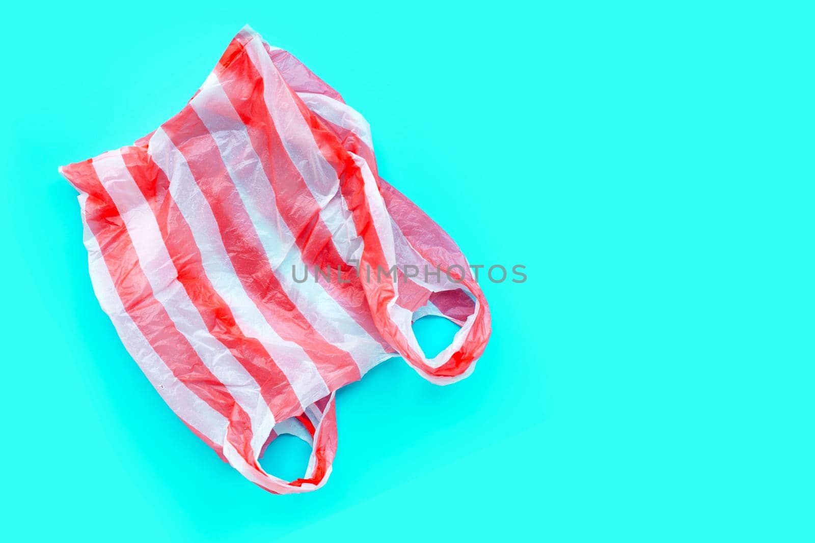 Colorful plastic bags on white background. Copy space