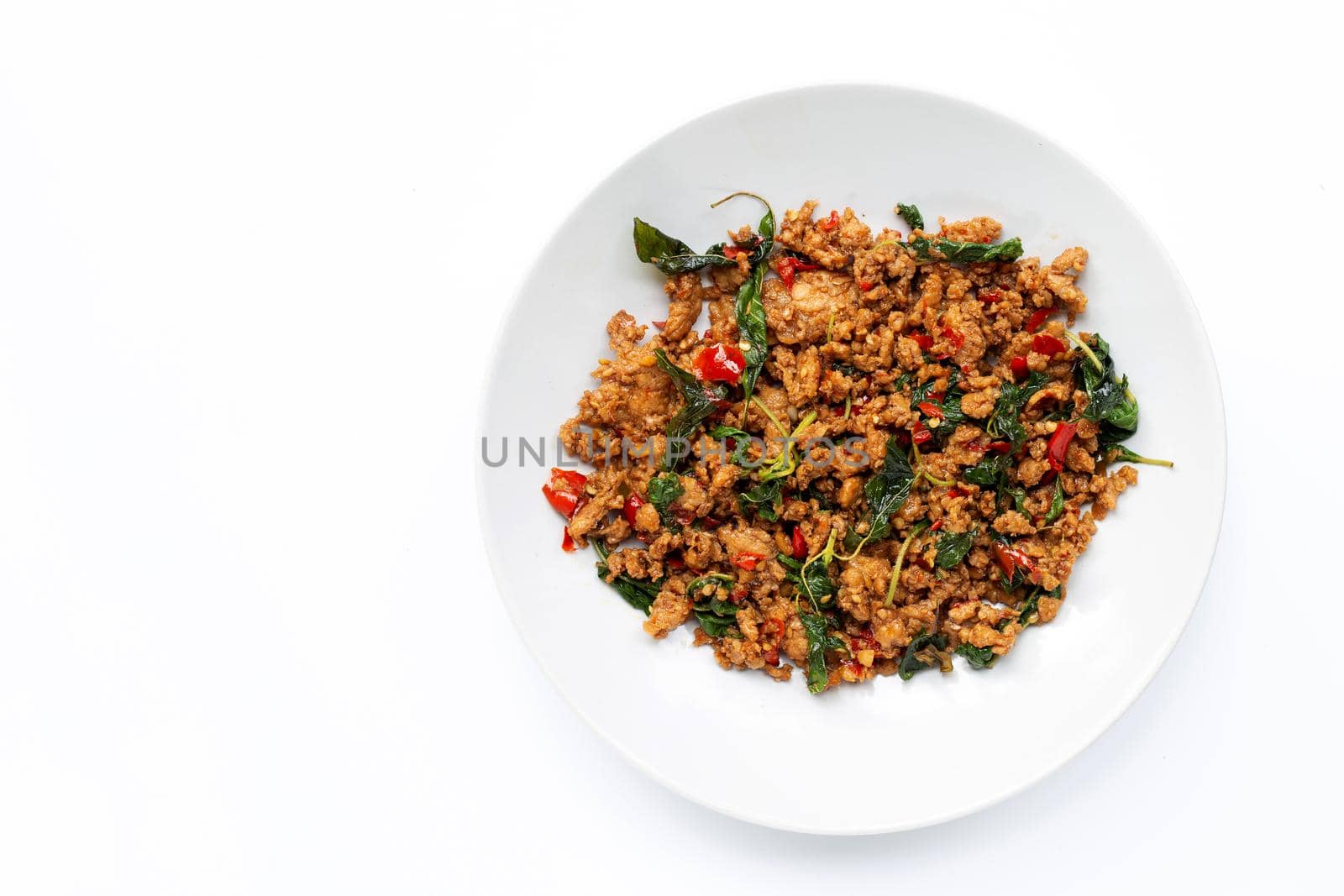 Thai food. Stir-fried minced pork with basil leaves on white background.