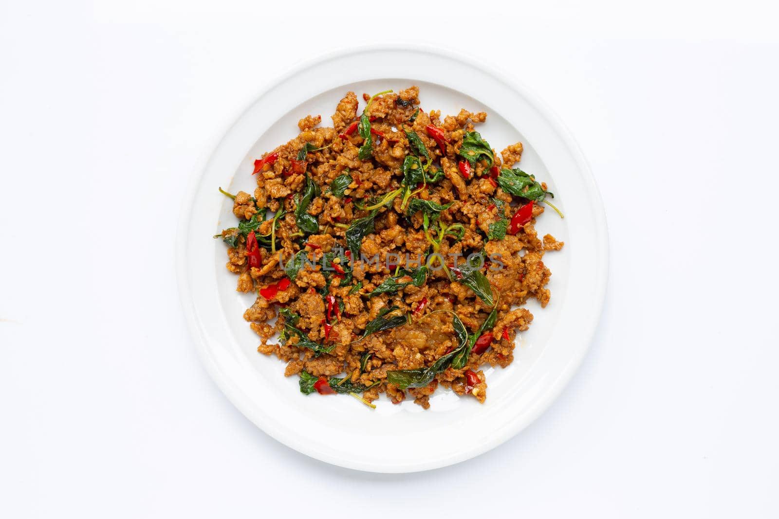 Thai food. Stir-fried minced pork with basil leaves on white background.