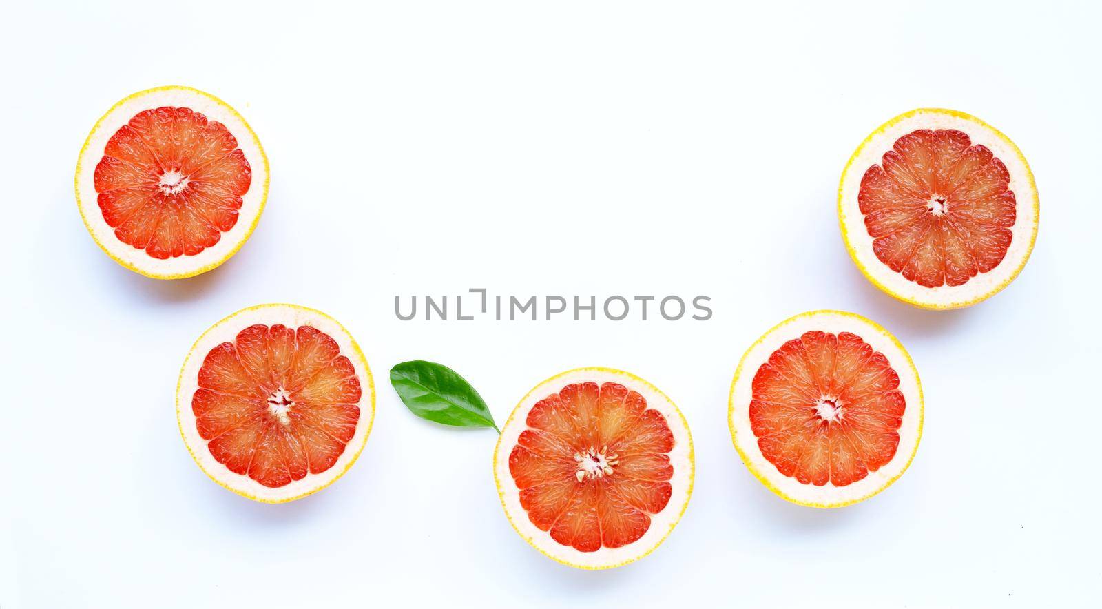 High vitamin C. Juicy grapefruit with leaf on white background.