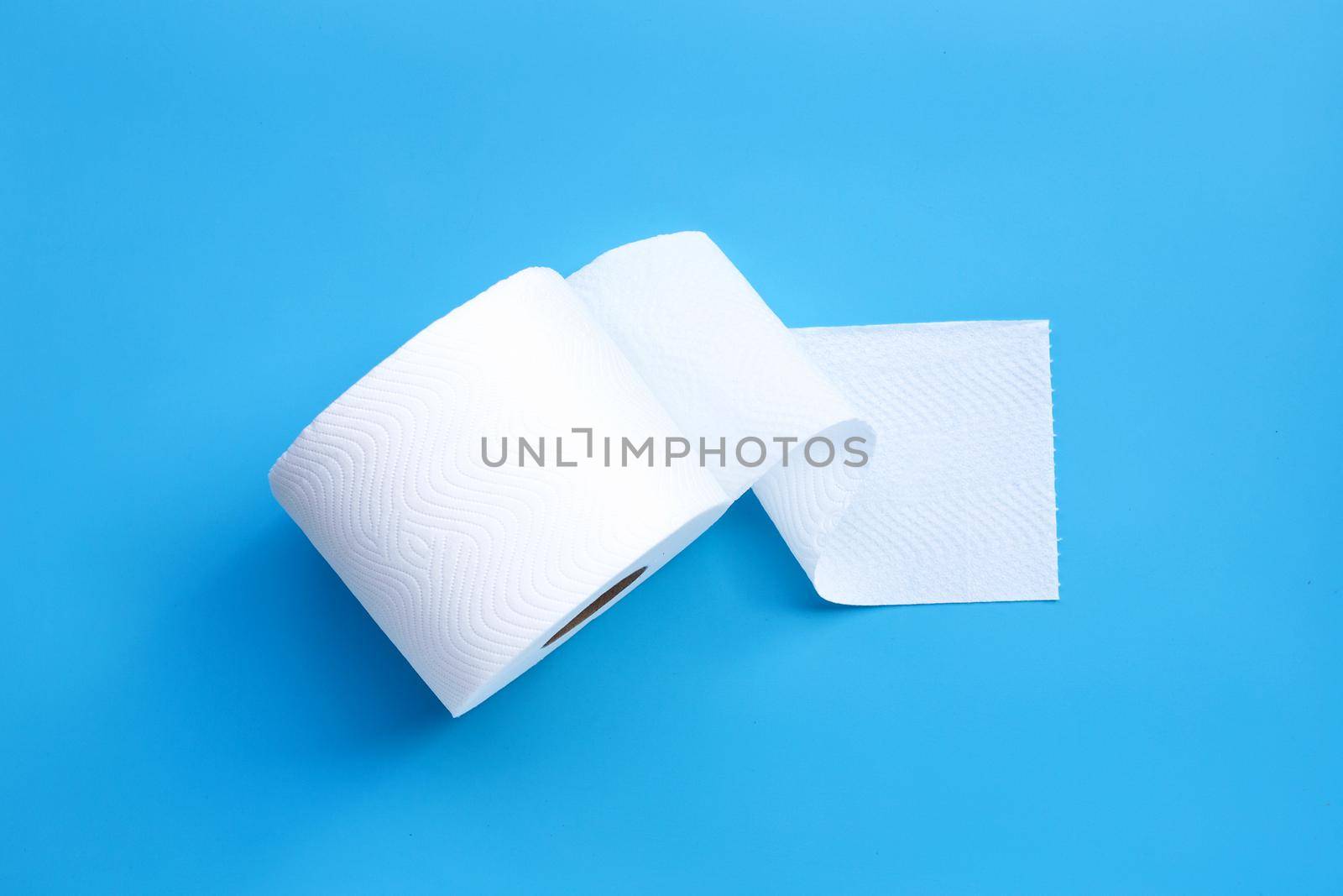 Toilet paper on blue background. Copy space