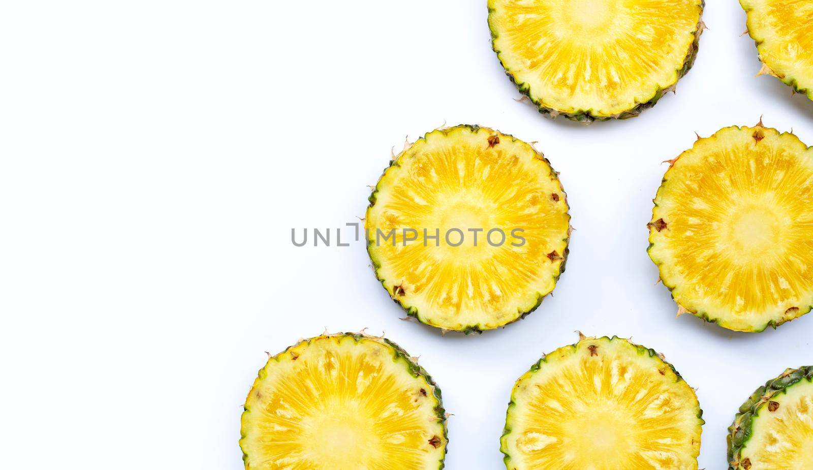 Fresh pineapple slices on white background. Top view