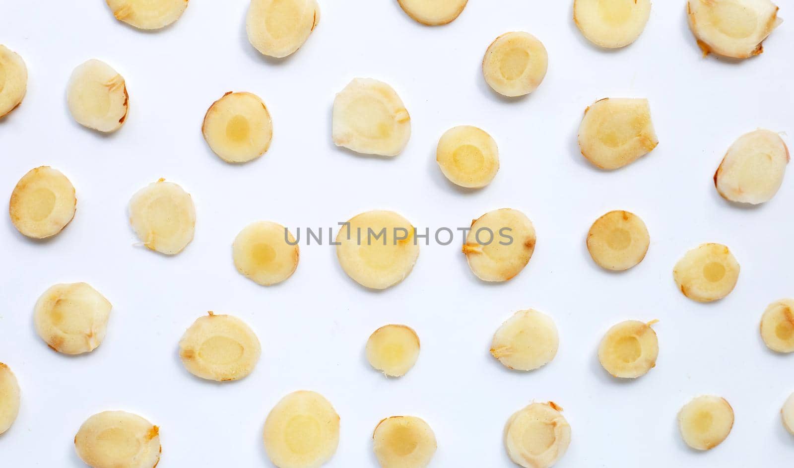 Fresh galangal  slices on white background. Top view