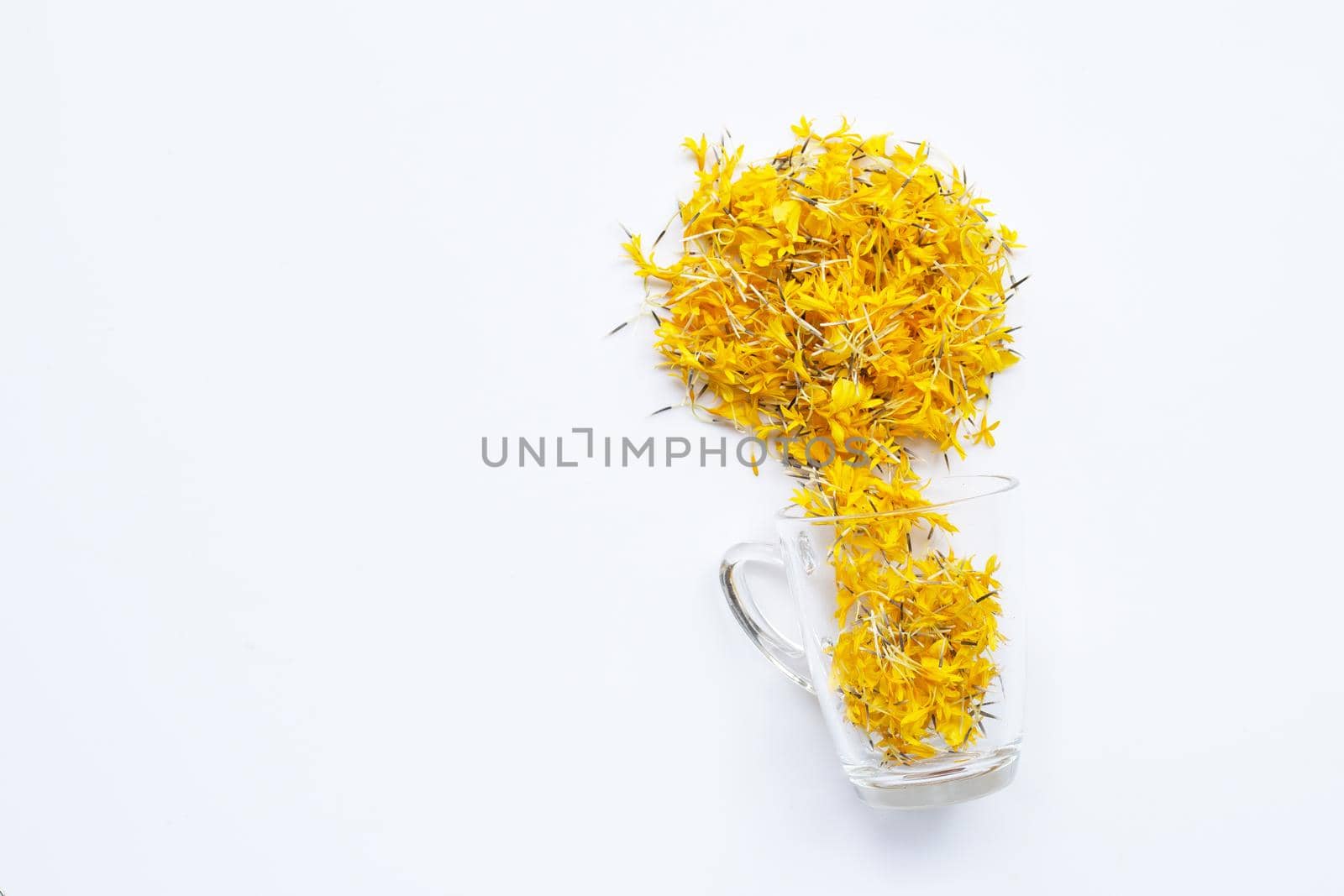 A glass cup with marigold flower petals on white background. Flower herbal tea concept.