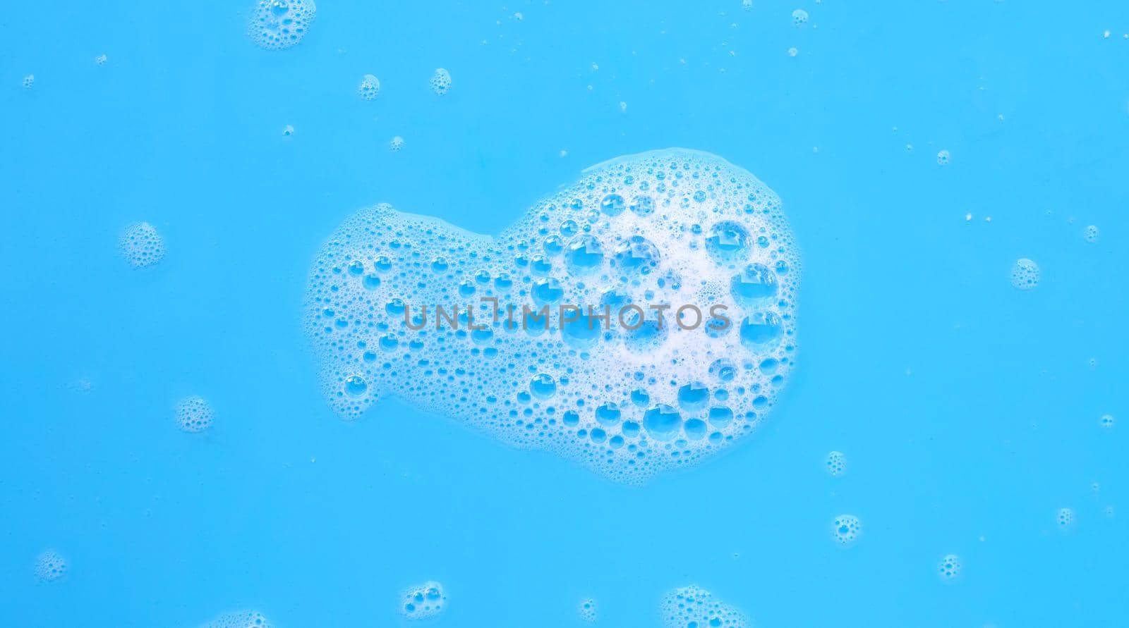 Foam on blue background. Top view