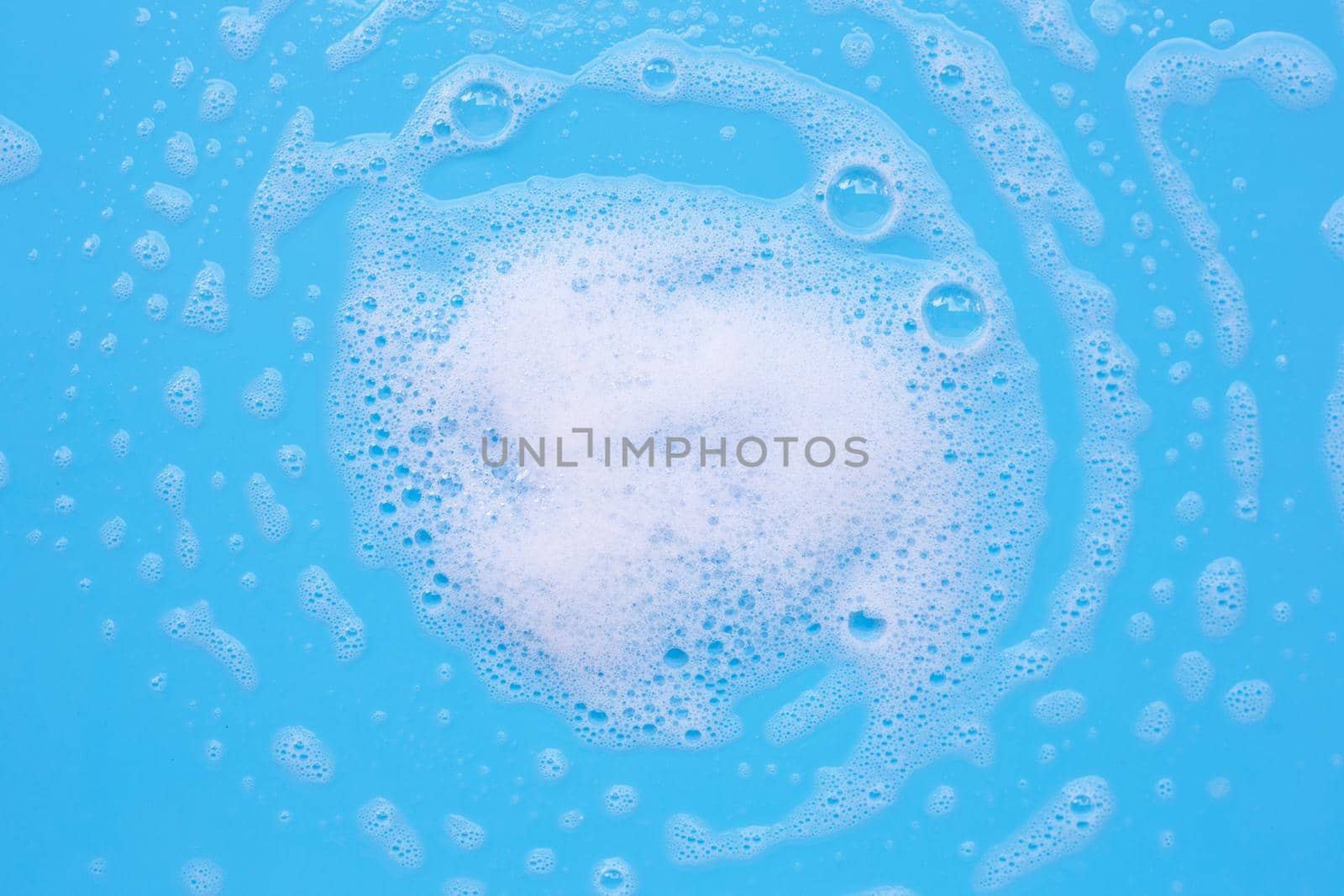 Foam on blue background. Top view