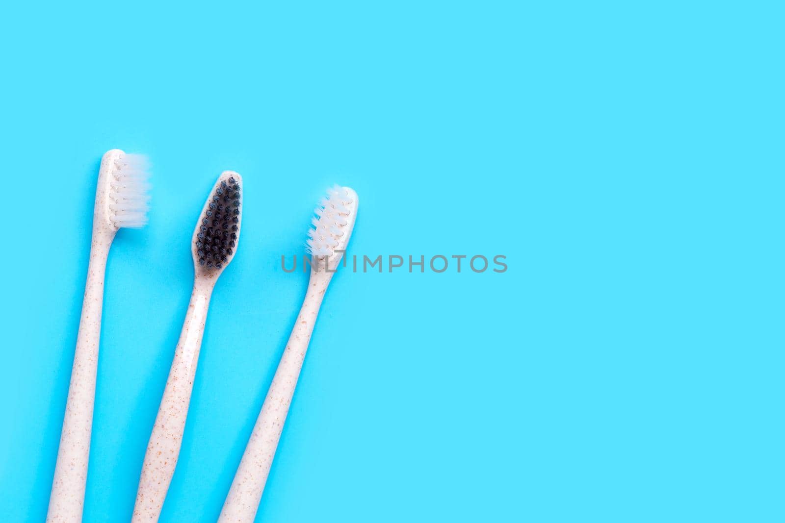 Toothbrushes on blue background. Top view by Bowonpat