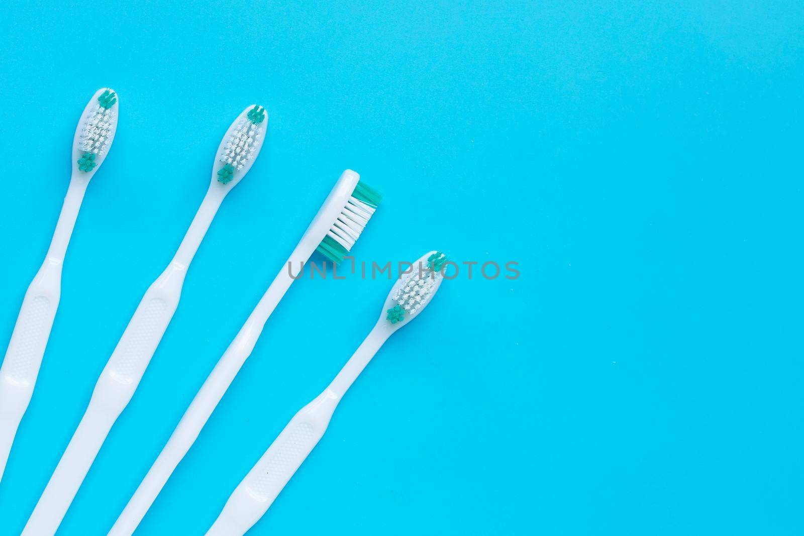 Toothbrushes on blue background. Top view