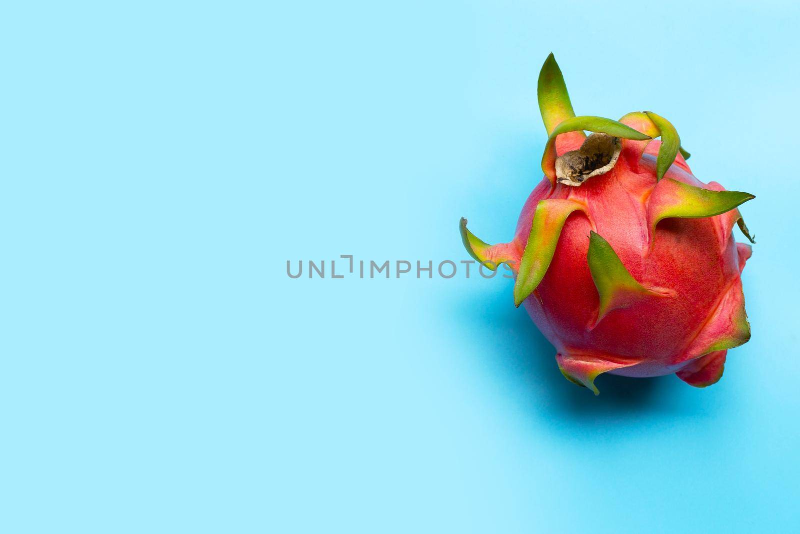 Dragon fruit or pitaya on blue background. Delicious tropical exotic fruit. Top view