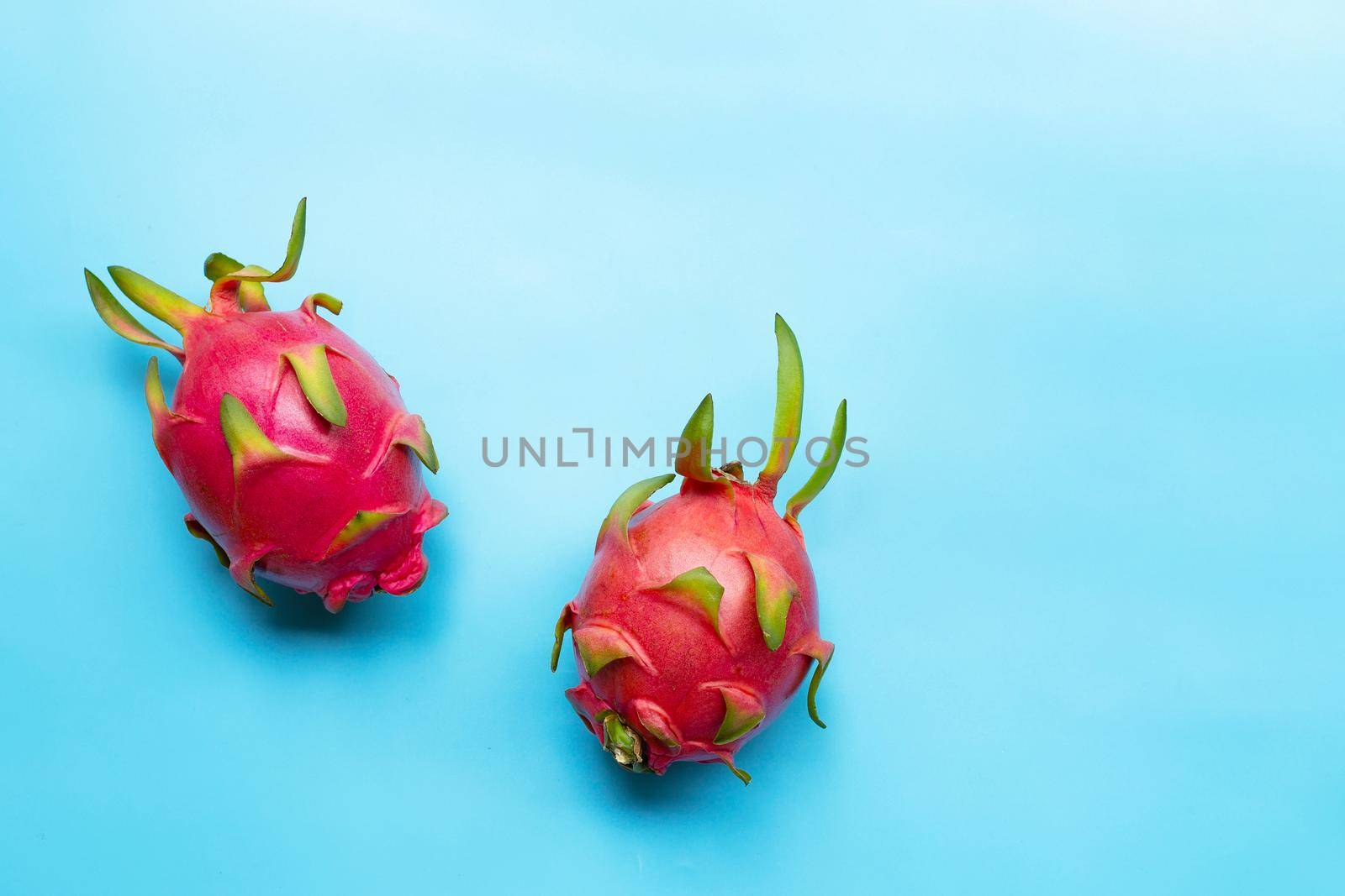 Dragon fruit or pitaya on blue background. Delicious tropical exotic fruit. Top view