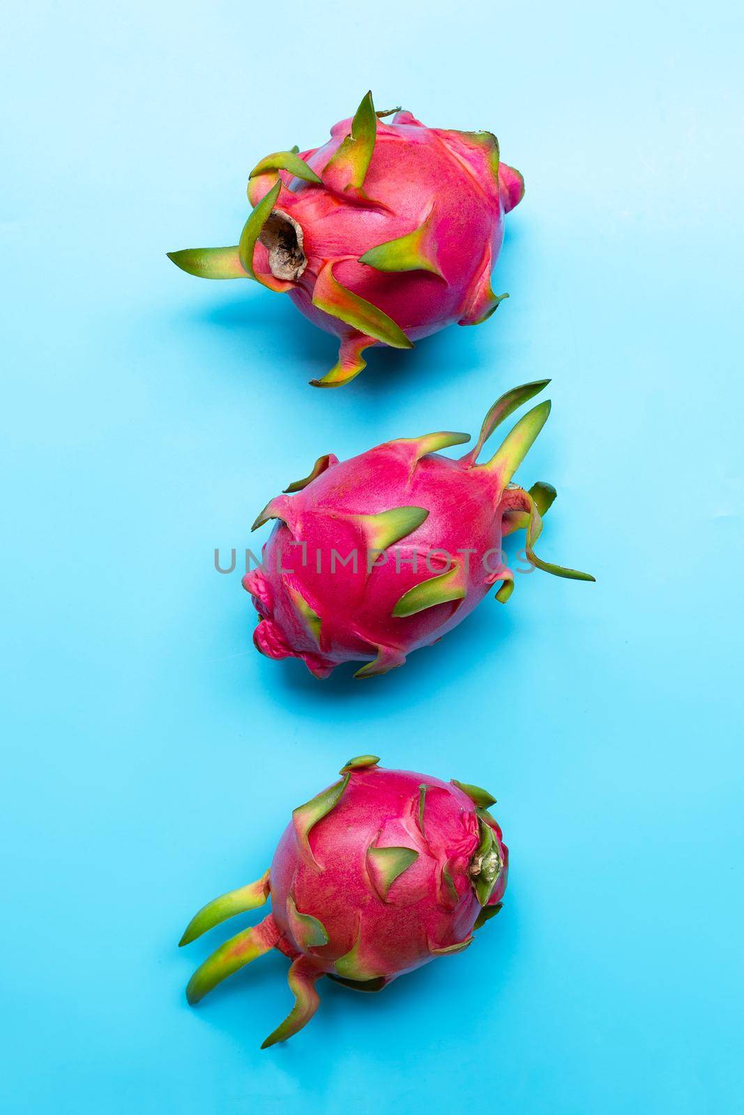 Dragon fruit or pitaya on blue background. Delicious tropical exotic fruit. Top view