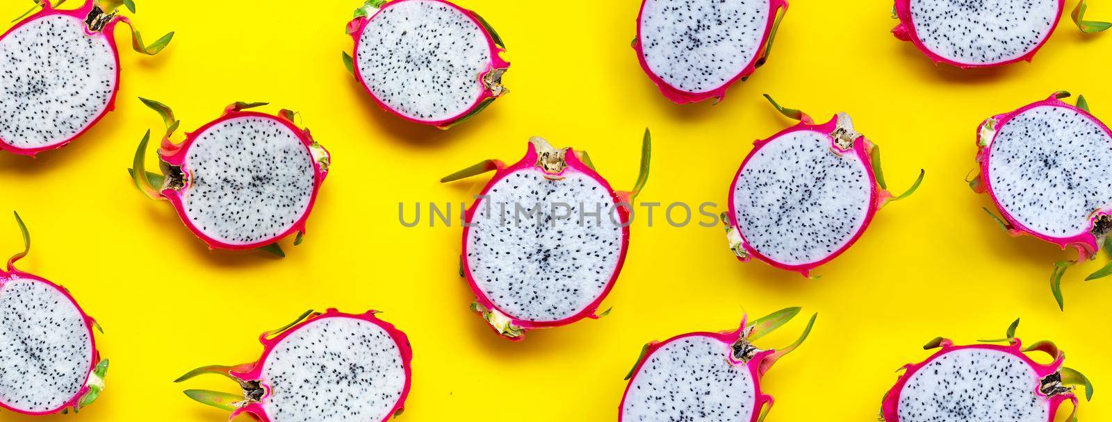 Dragon fruit or pitaya on yellow background. Delicious tropical exotic fruit. Top view
