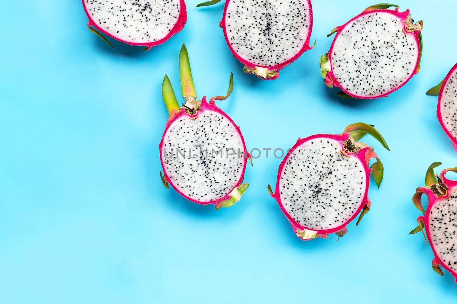 Dragon fruit or pitaya on blue background. Delicious tropical exotic fruit. Top view