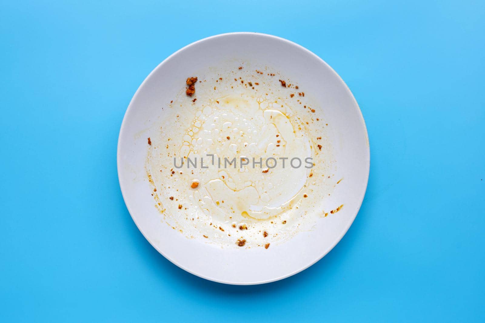 Dirty dish on blue background. Top view