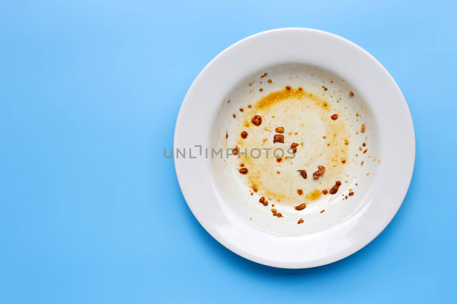Dirty dish on blue background. Top view