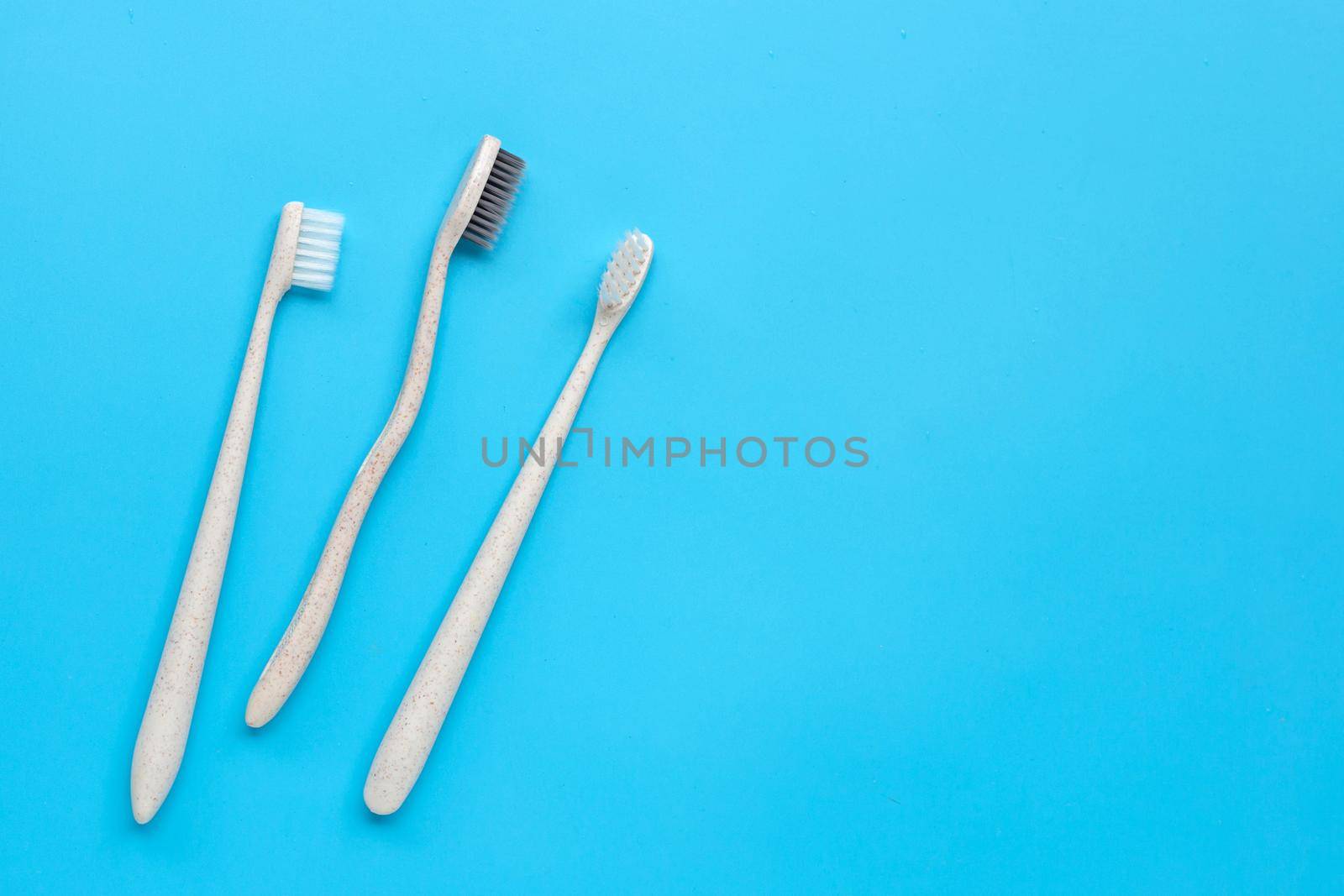 Toothbrushes on blue background. Top view