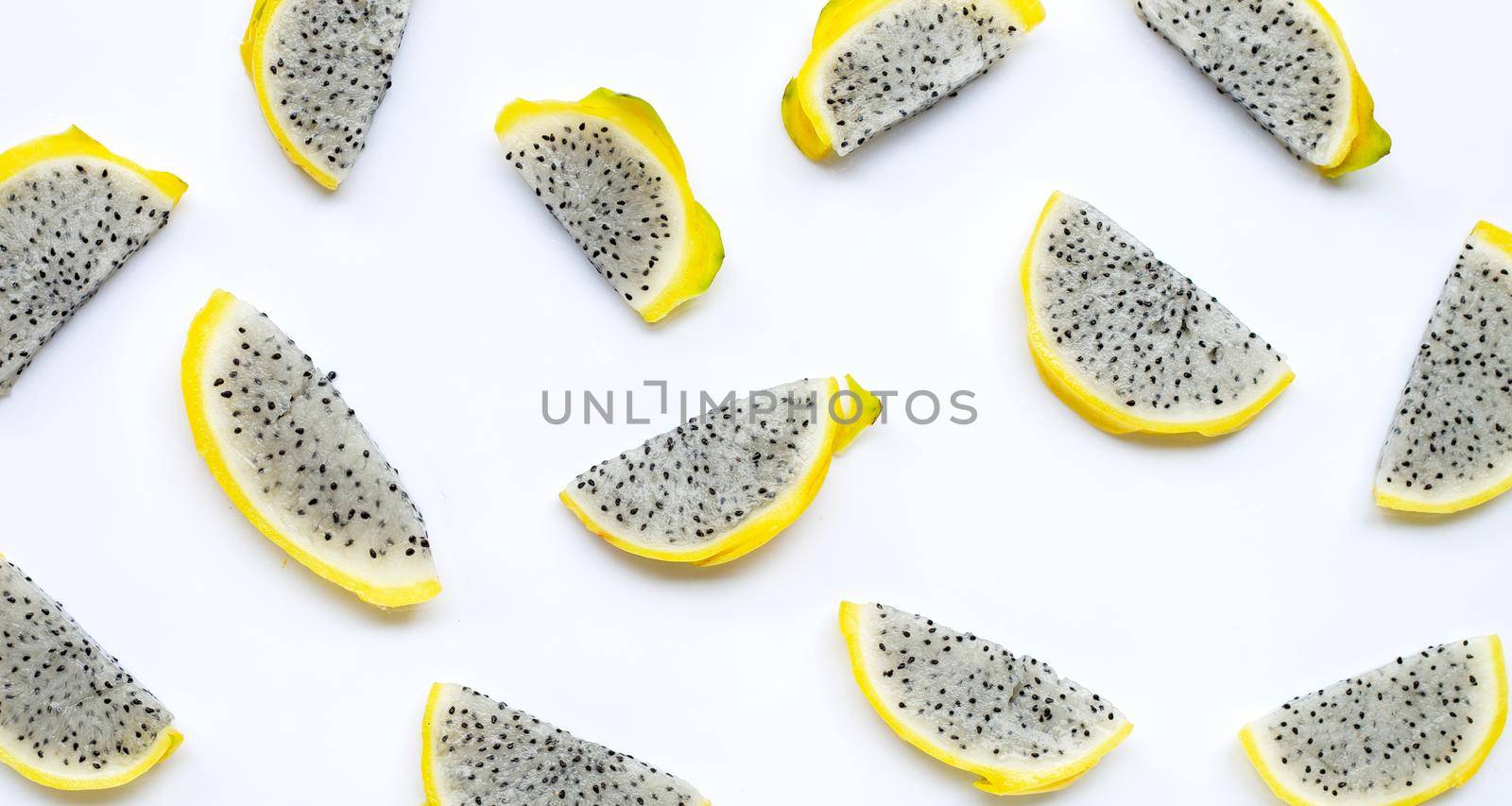 Yellow pitahaya or dragon fruit slices on white background. Copy space