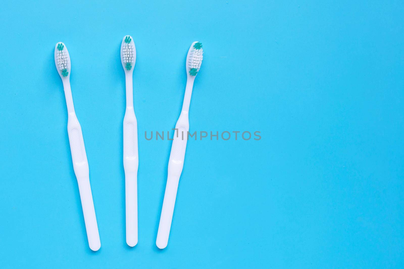 Toothbrushes on blue background. Top view