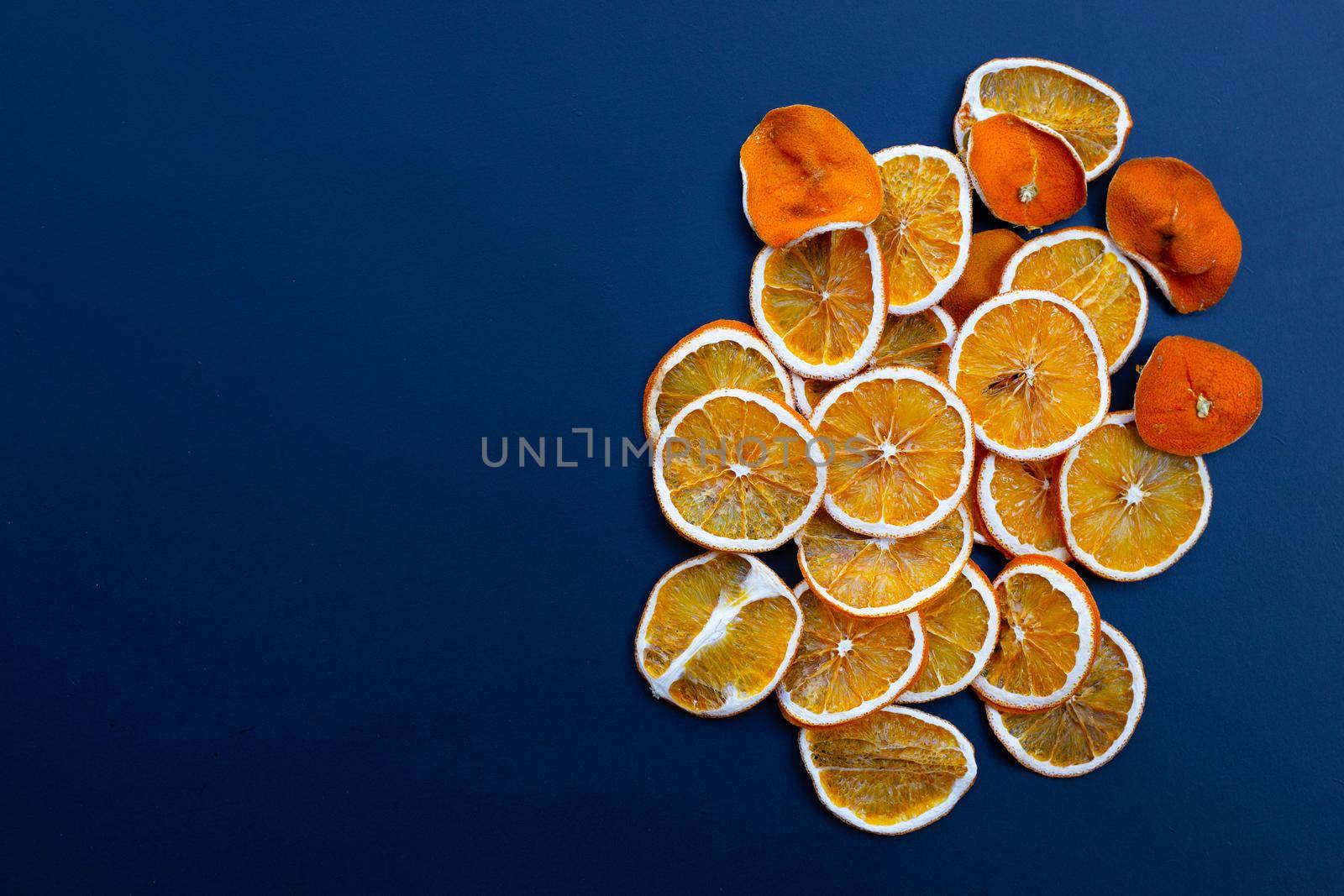Dried orange slices on dark background.
