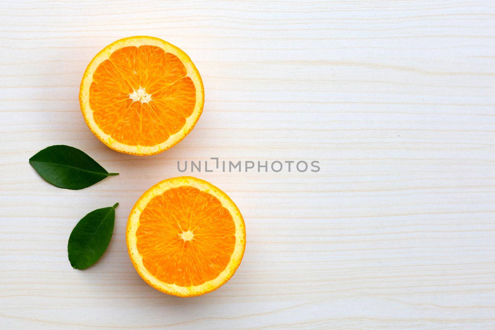 High vitamin C, Juicy and sweet. Fresh orange fruit with green leaves on table texture background.