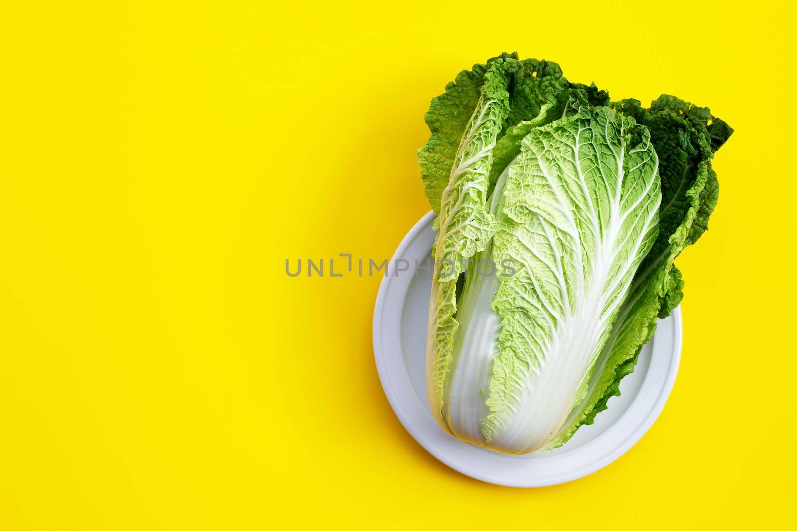 Chinese cabbage on yellow background. Copy space