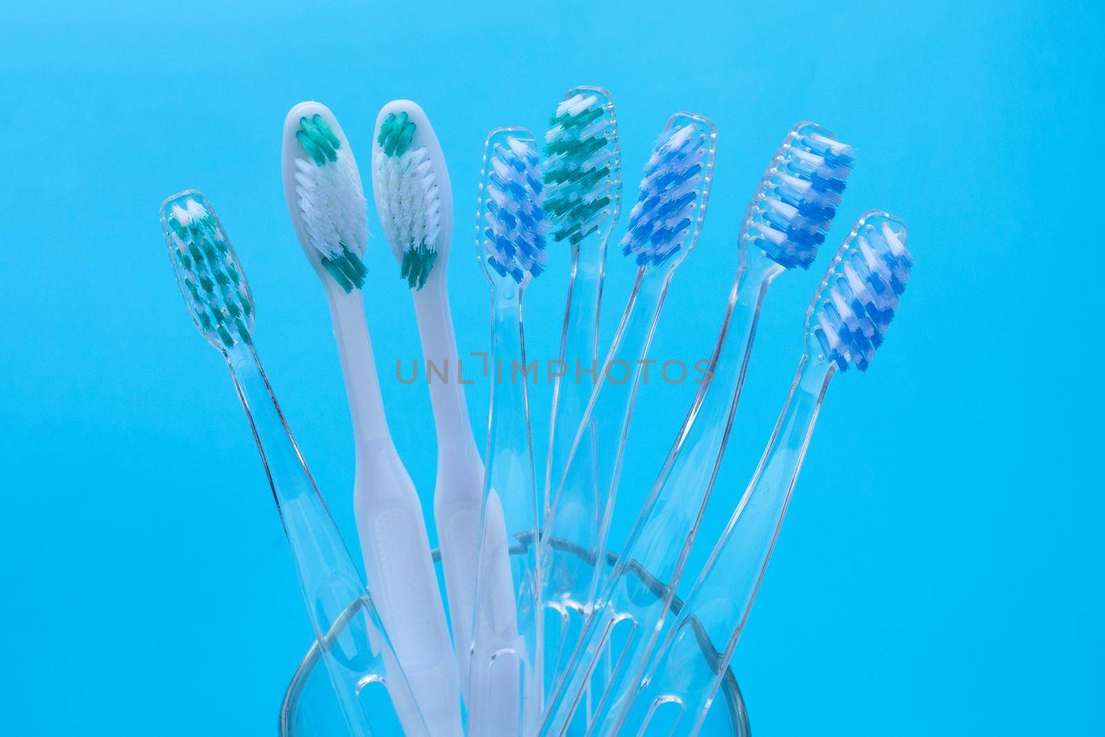 Toothbrushes on blue background. Dental care concept