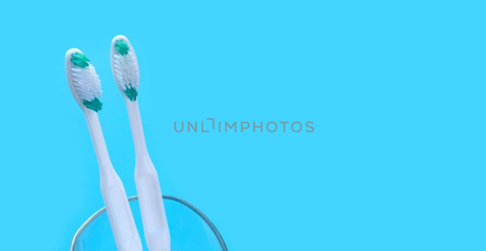 Toothbrushes on blue background. Dental care concept
