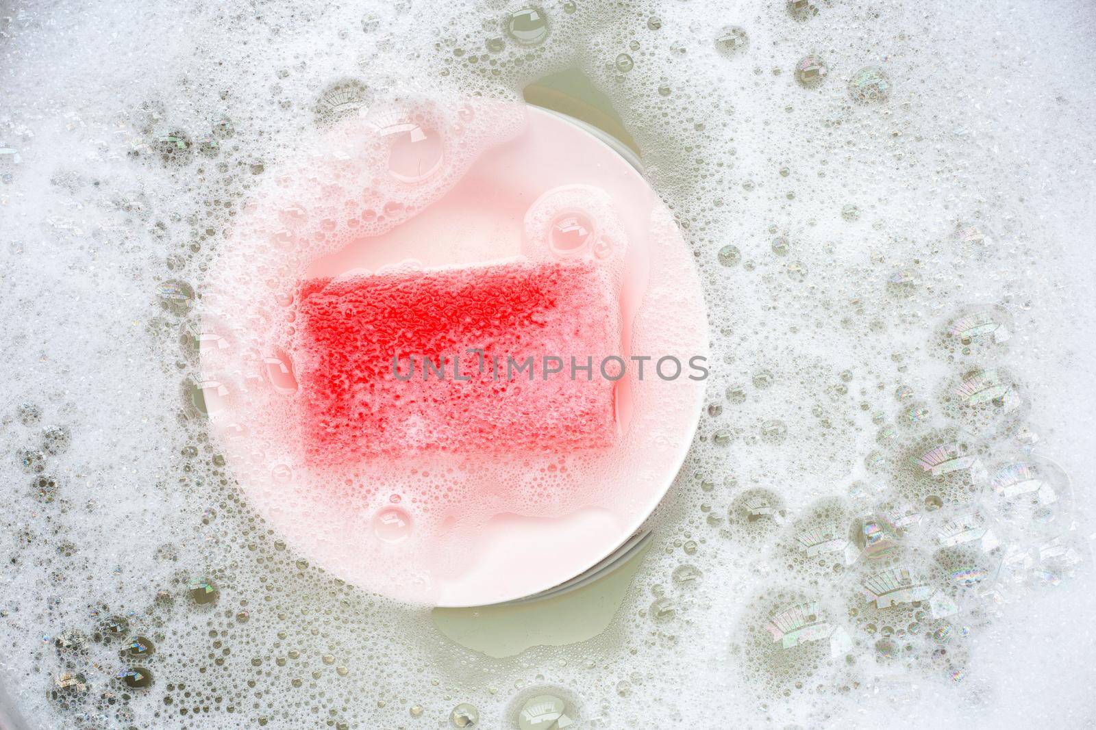 Washing dishes, Close up of utensils soaking in kitchen sink.