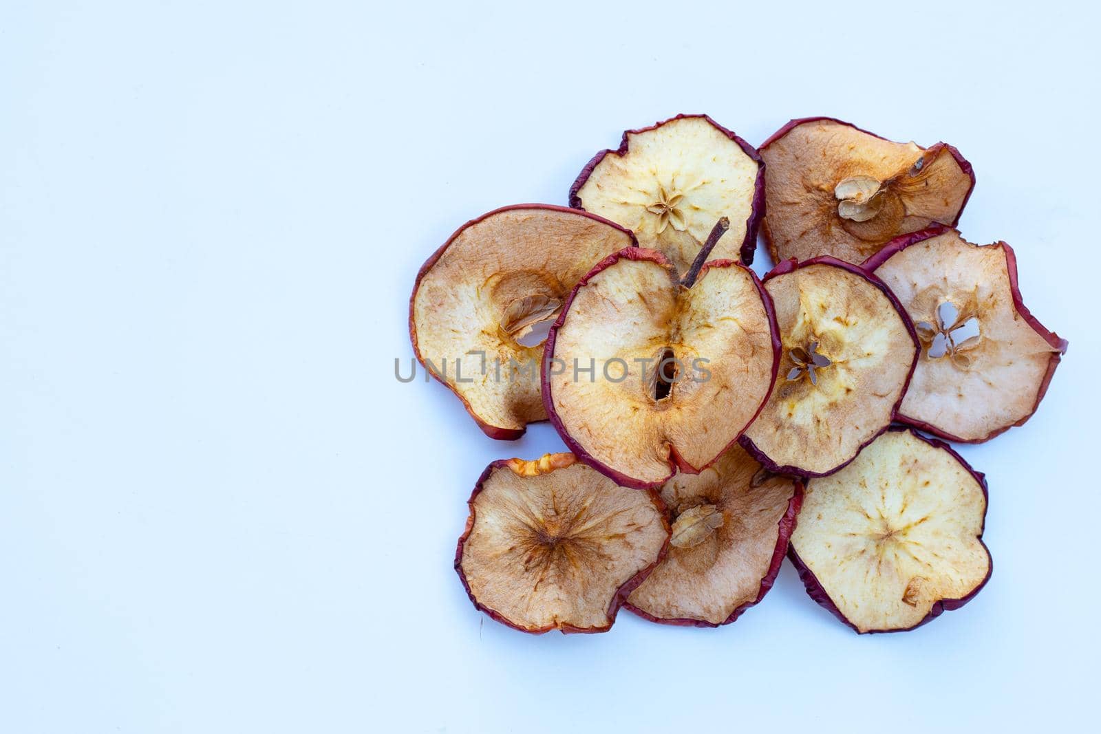 Dried apple slices on white background
