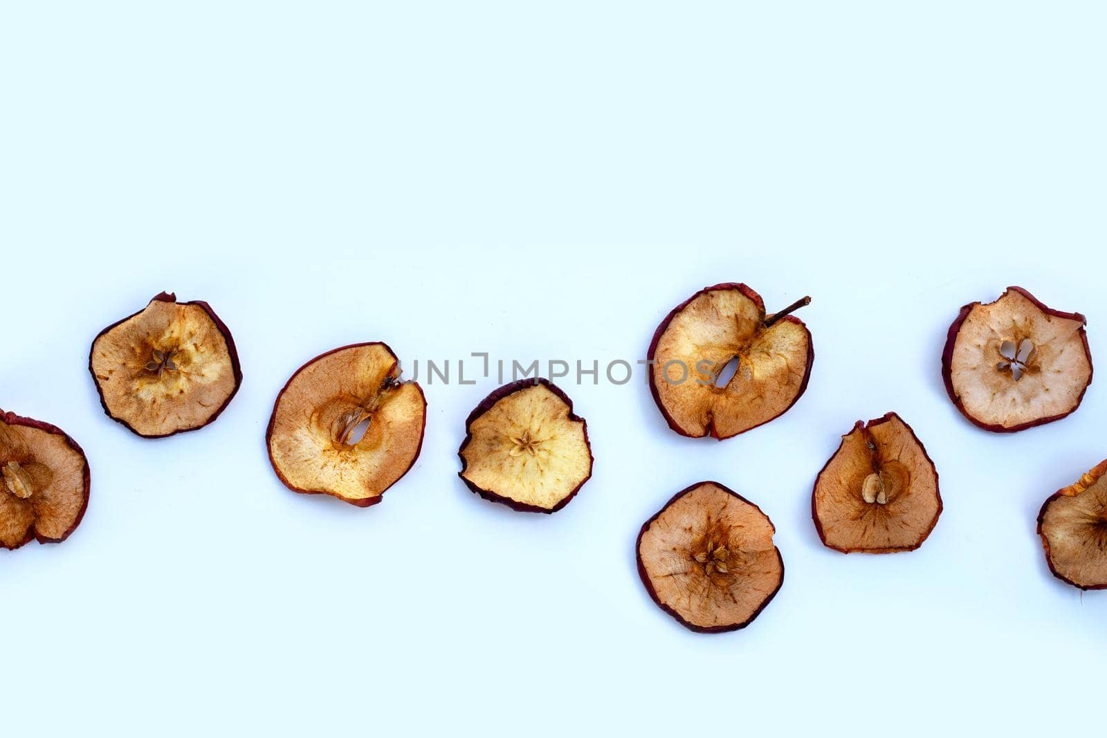 Dried apple slices on white background