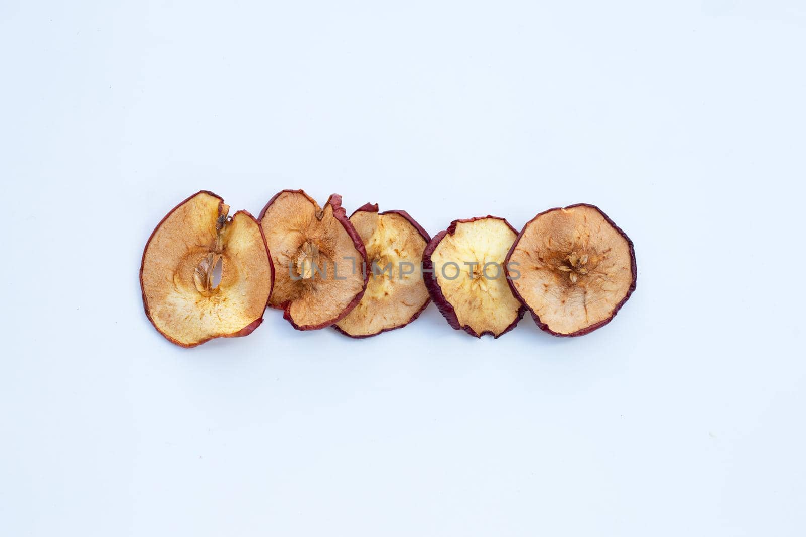 Dried apple slices on white background