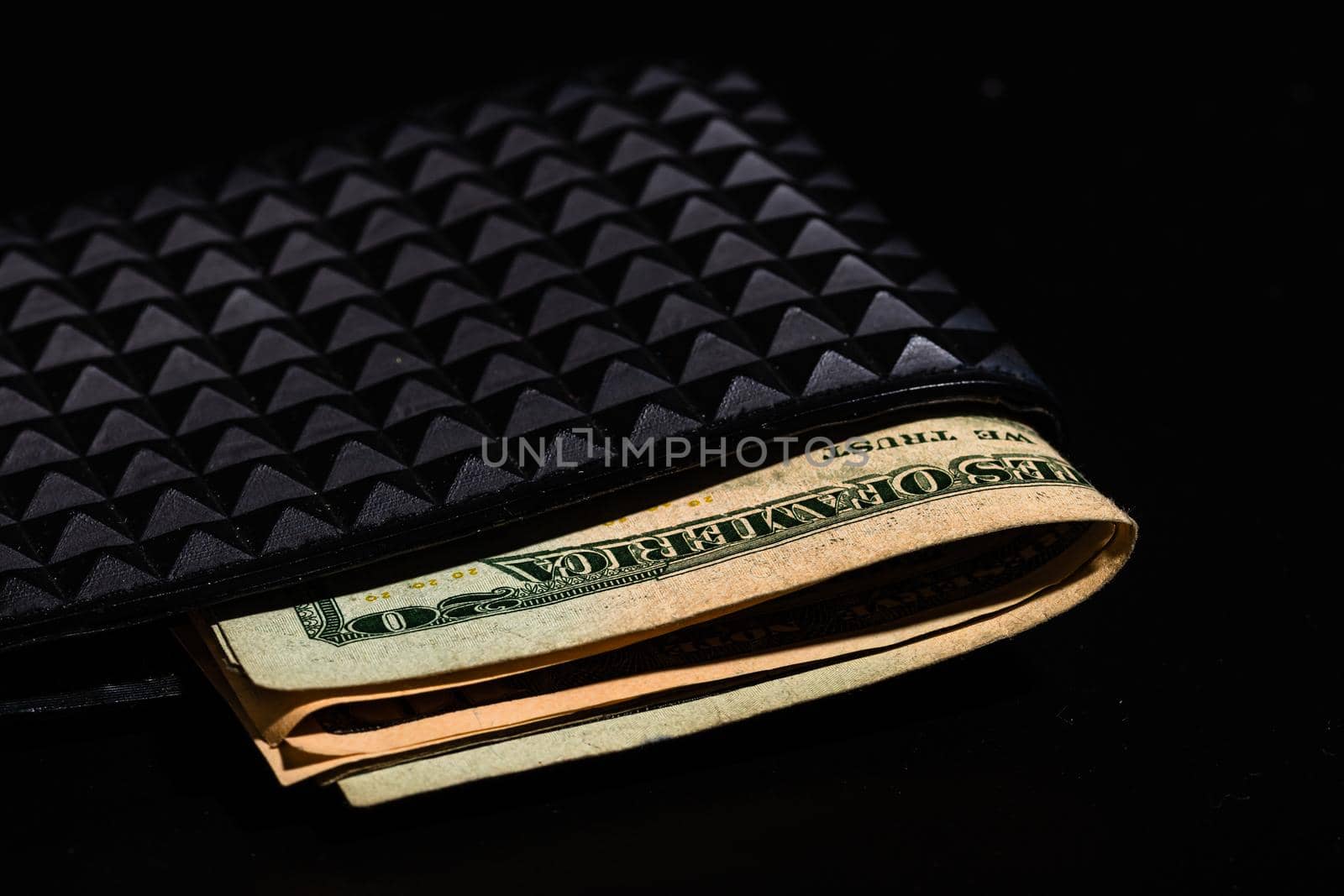 Dollars money banknotes in a black wallet isolated.