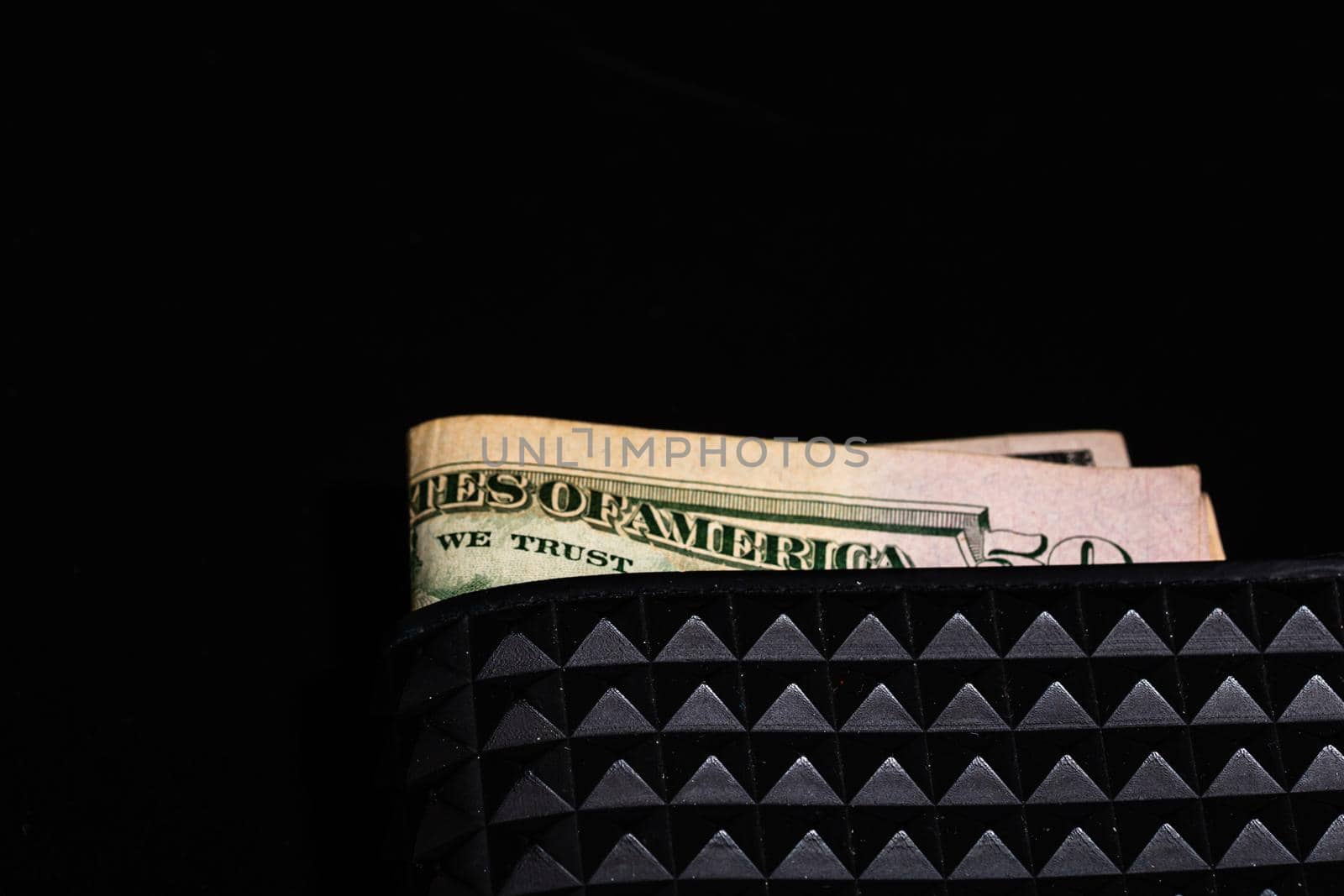 Dollars money banknotes in a black wallet isolated.