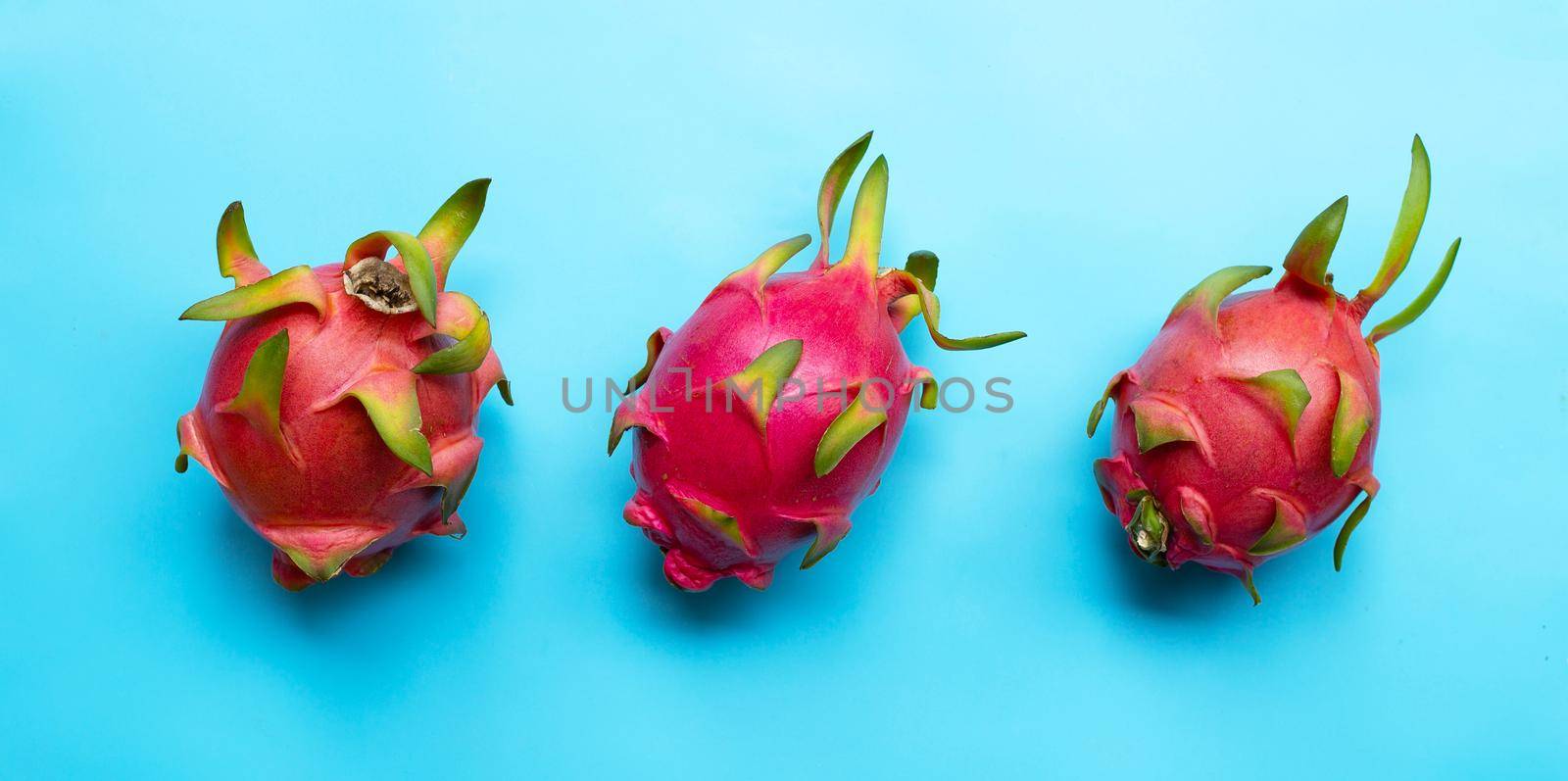 Dragon fruit or pitaya on blue background. Delicious tropical exotic fruit. Top view