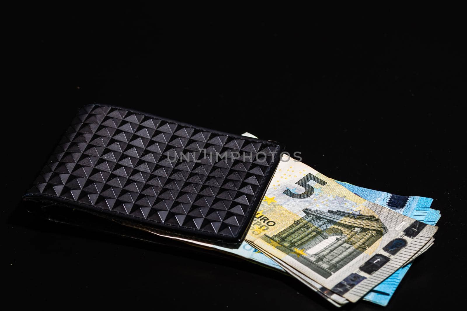 5 Euro money banknotes in black wallet isolated