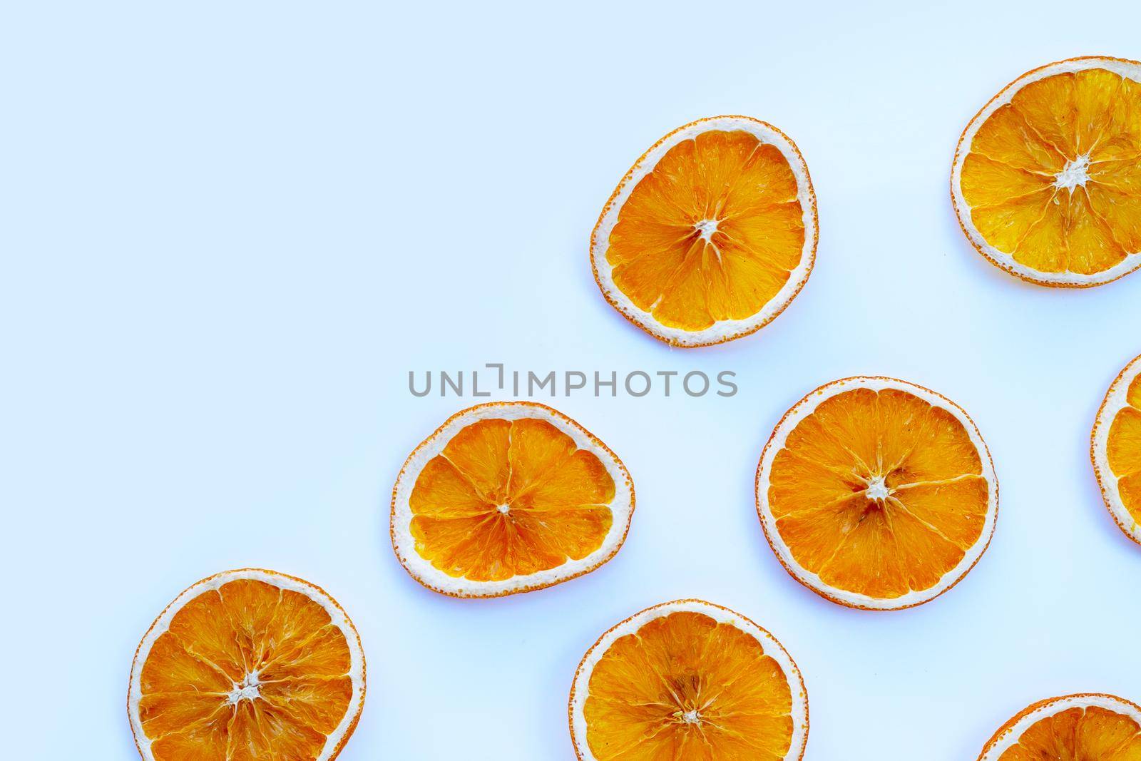 Dried orange slices on white background.