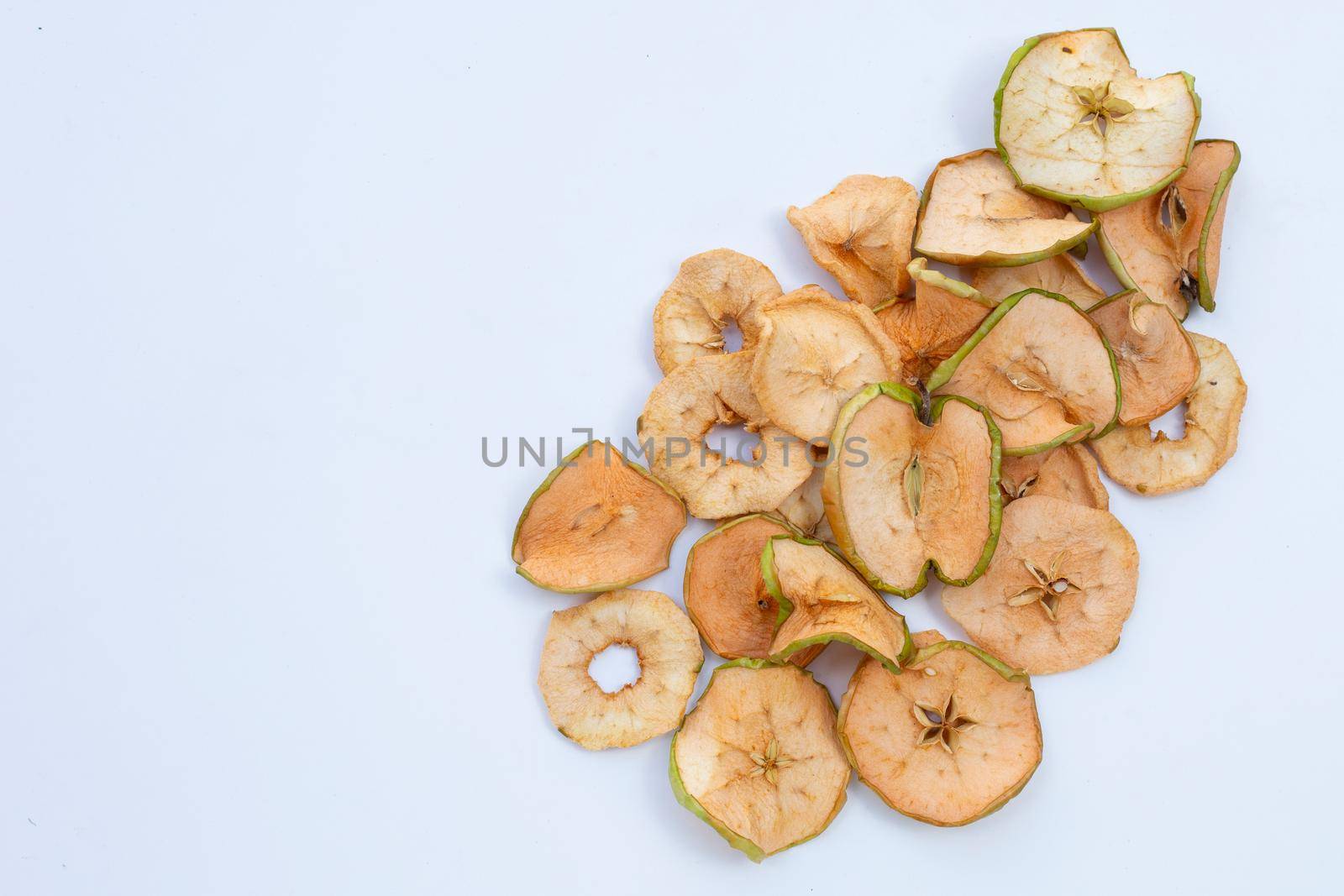 Dried apple slices on white background