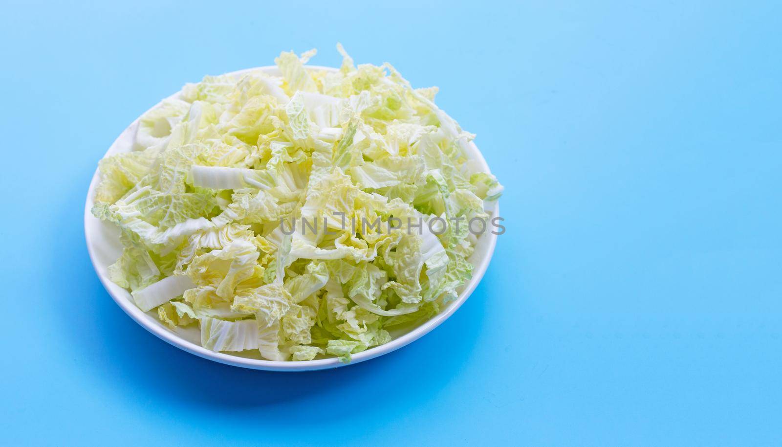 Chinese cabbage sliced on blue background by Bowonpat