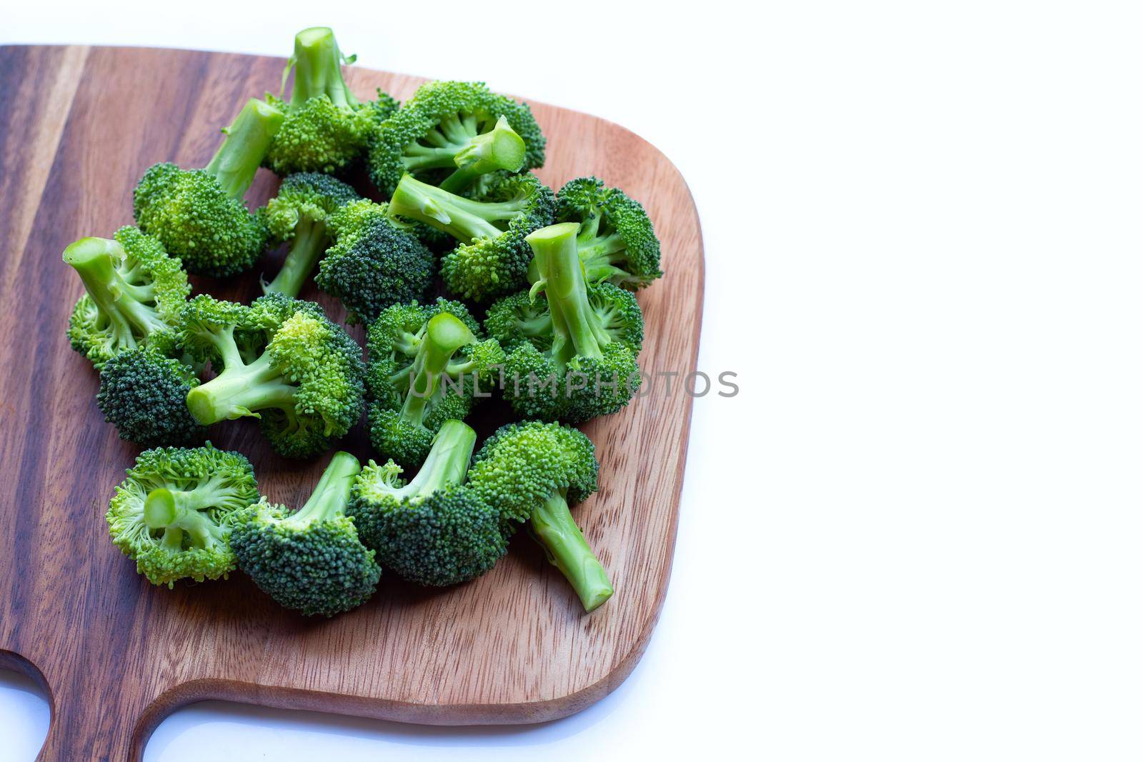 Fresh green broccoli on wooden cutting baound on white background. by Bowonpat