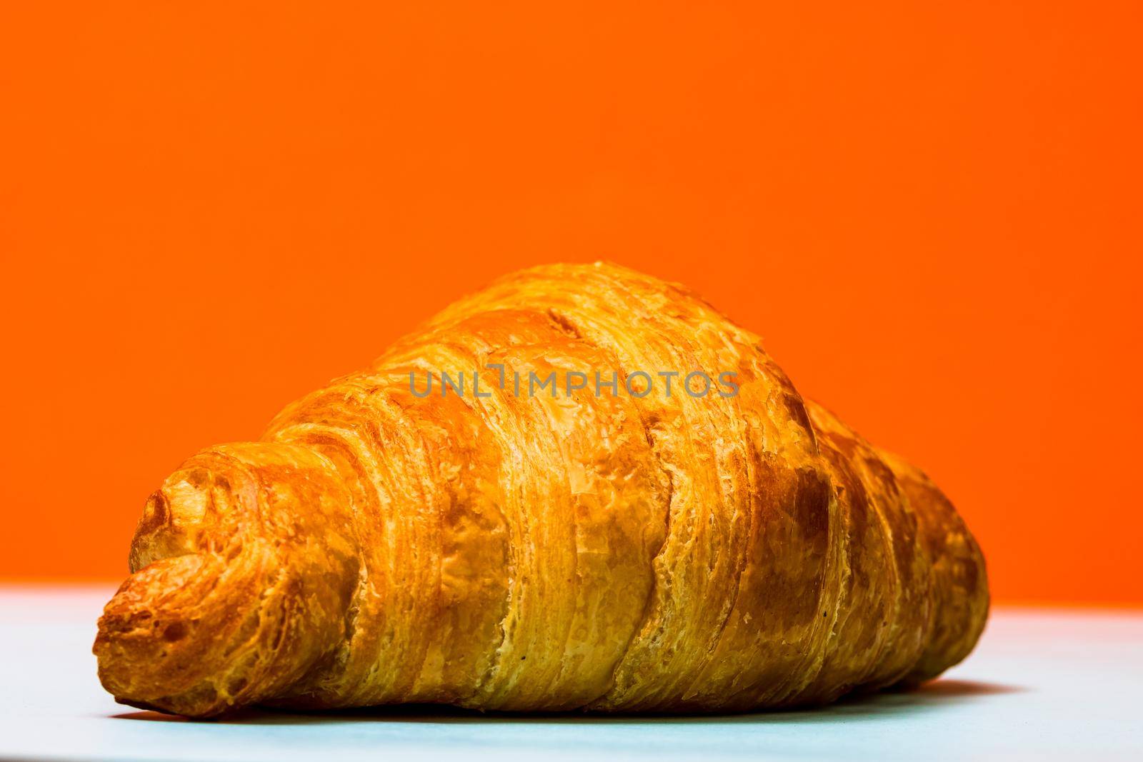 Detail of fresh croissant isolated, french breakfast concept.