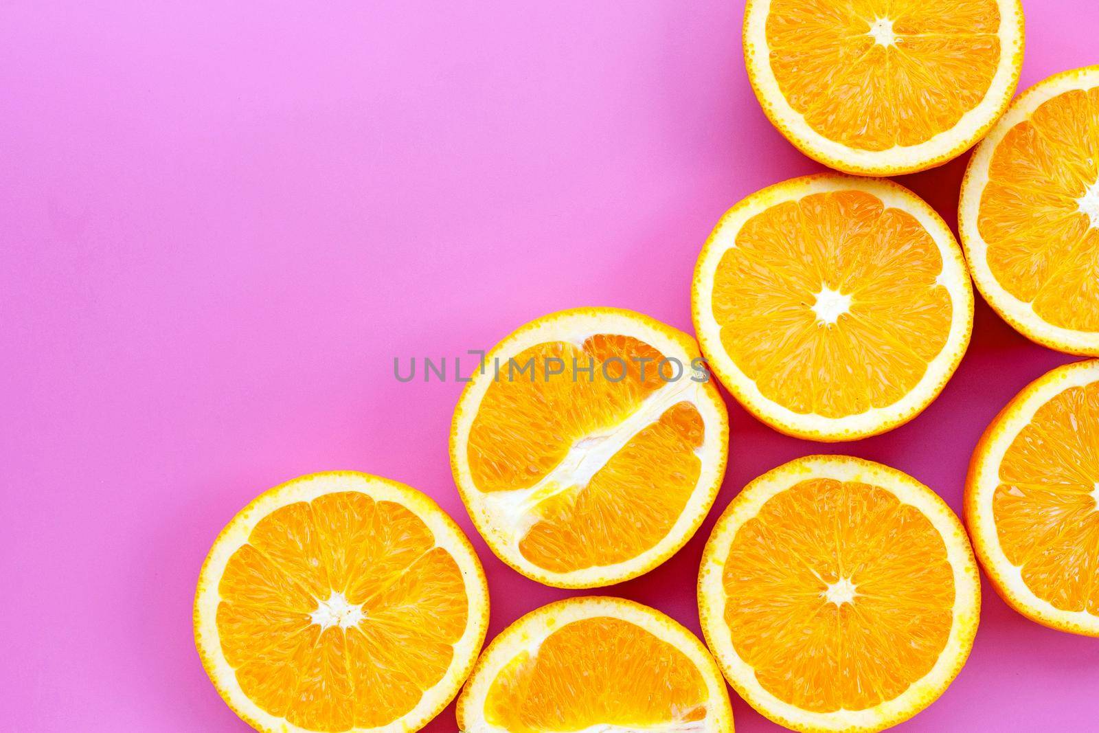 Sliced oranges on pink background. High vitamin C, Juicy and sweet. by Bowonpat