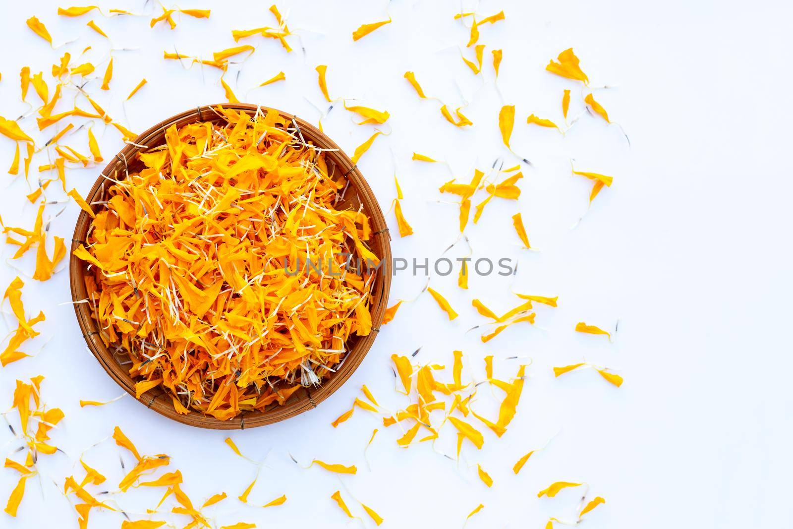 Marigold flower petals on white background.