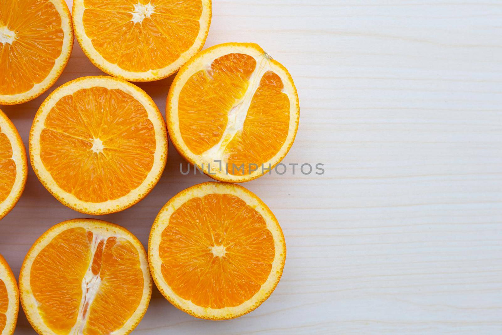 Sliced oranges on table background. High vitamin C, Juicy and sweet. by Bowonpat