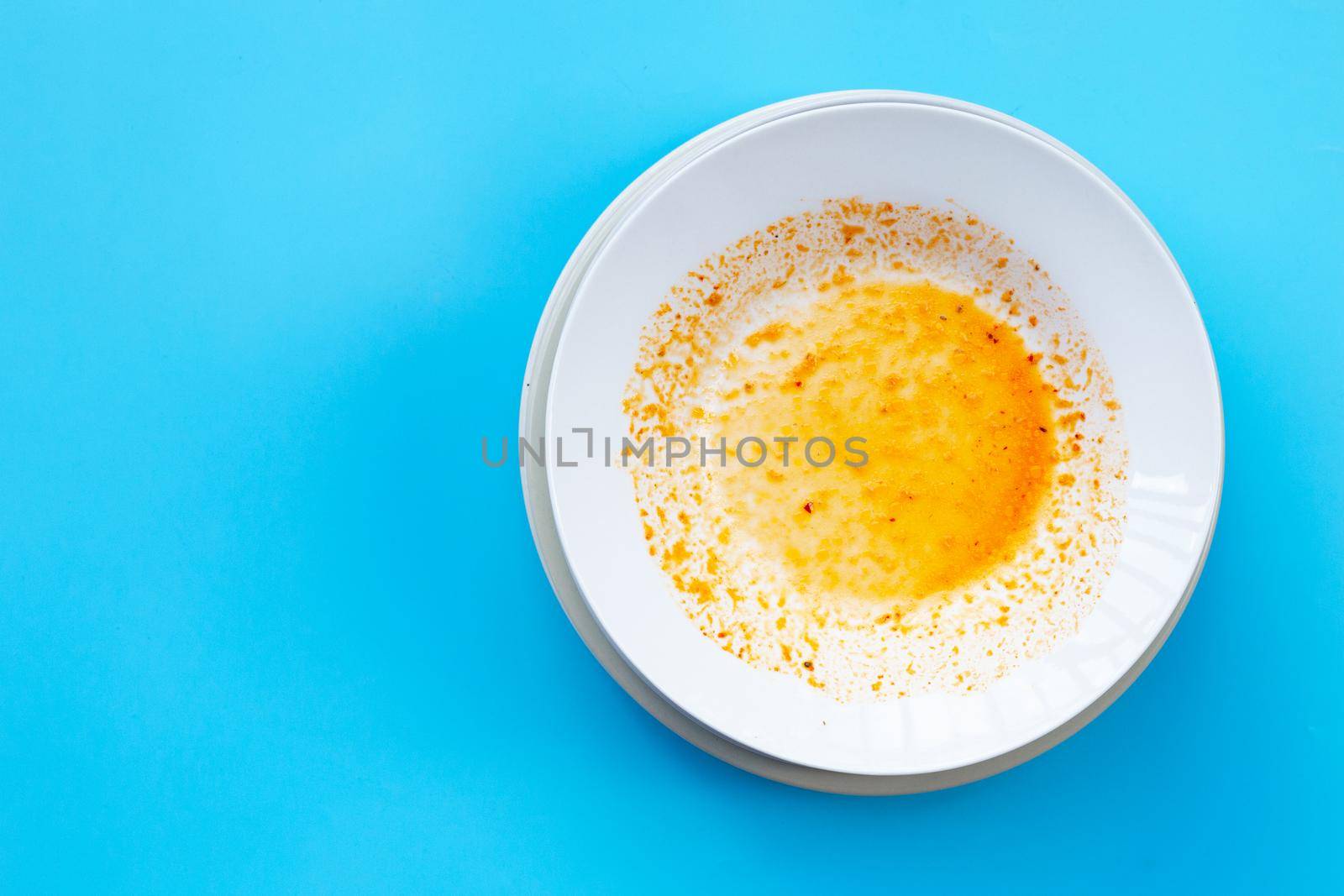 Dirty dishes on blue  background. Top view by Bowonpat