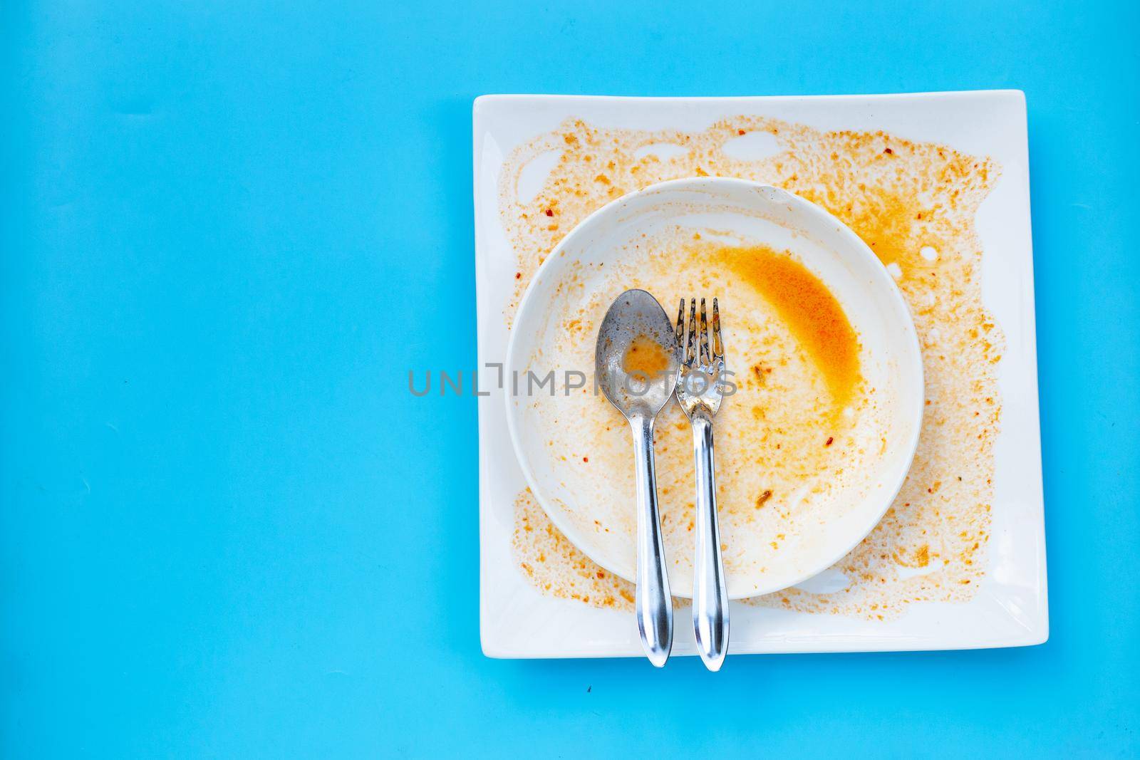 Dirty dishes on blue  background. Top view