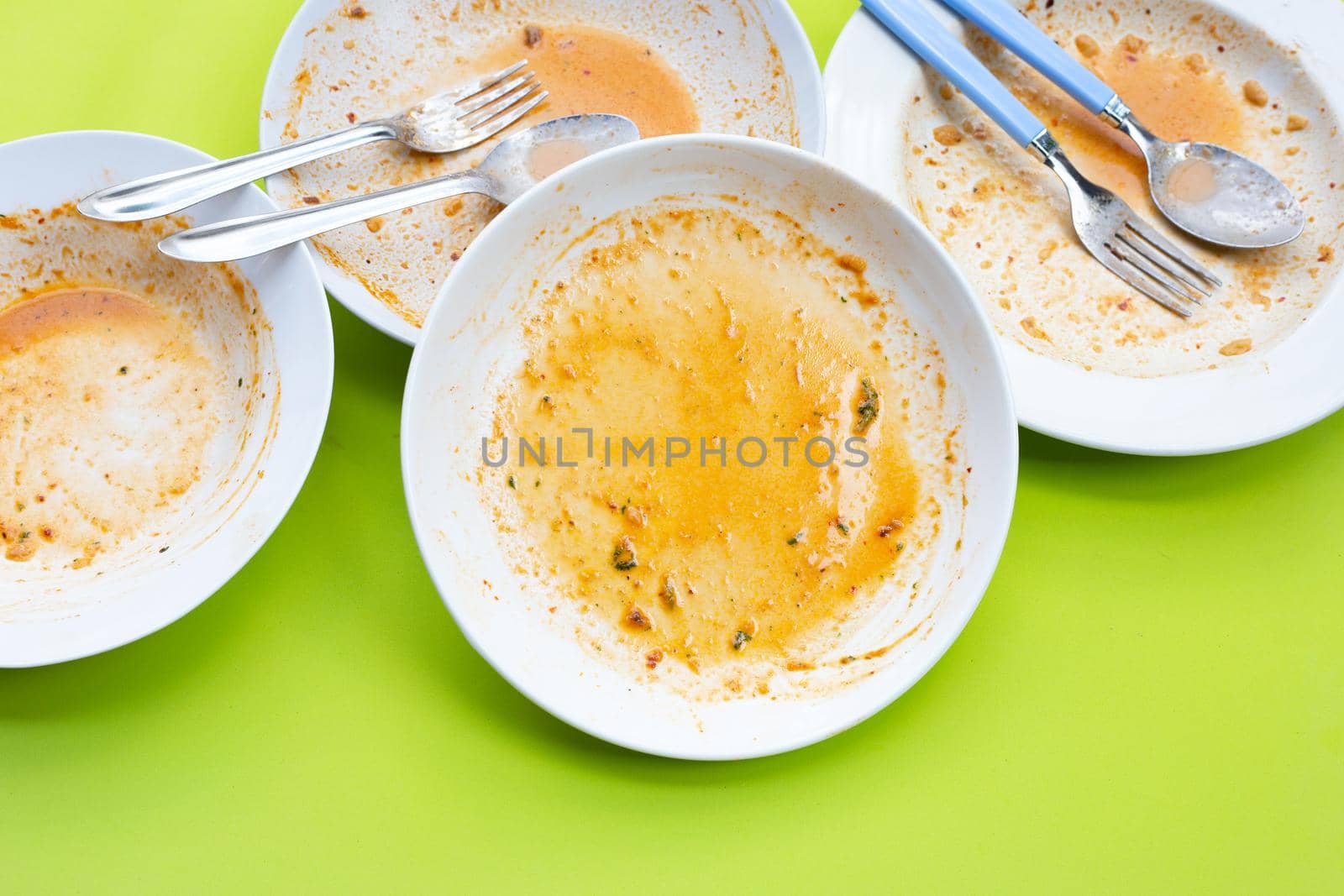 Dirty dishes on green background. Top view