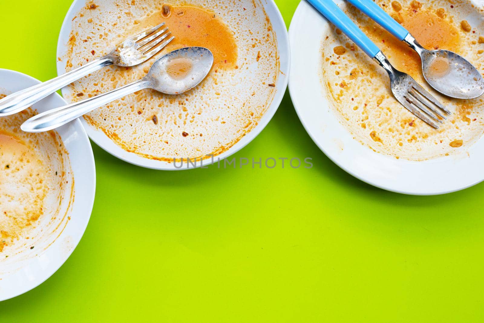 Dirty dishes on green background. Top view