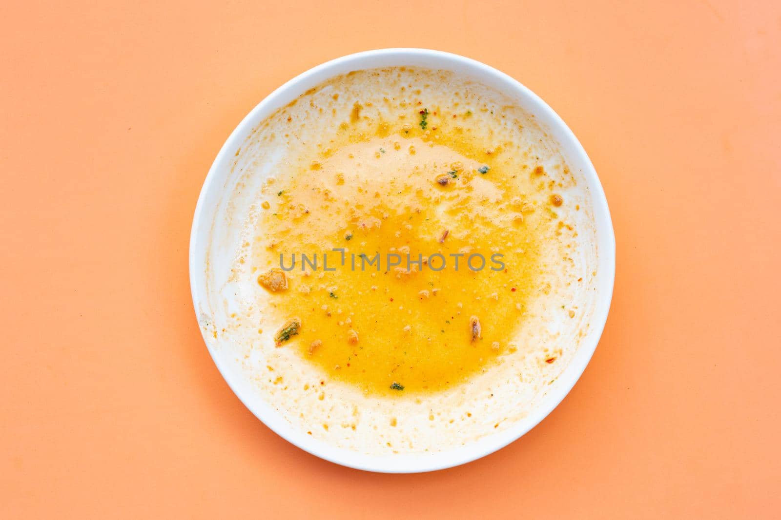 Dirty dish on orange background. Top view